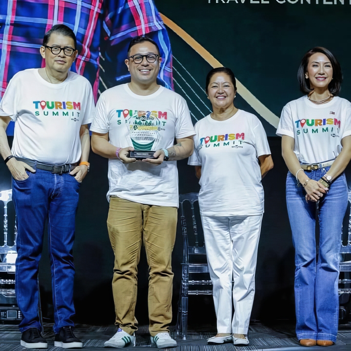 Paolo Rigotti receiving the Special Award for Travel Content Creation by GoNegosyo with Joey Concepcion, First Lady Liza Marcos, and Tourism Secretary Christina Frasco