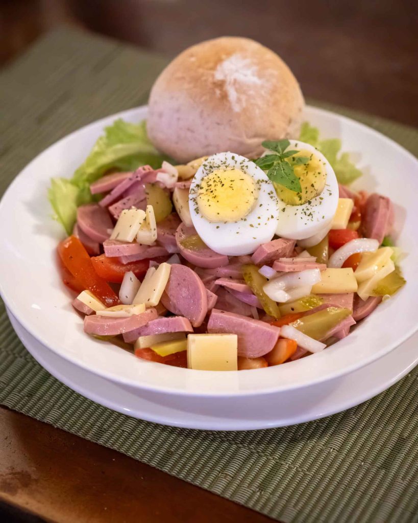 Traditional Swiss Wurstsalat (Sausage Salad) featuring Cervelat, cheese, and pickles—a perfect light lunch in Panglao.