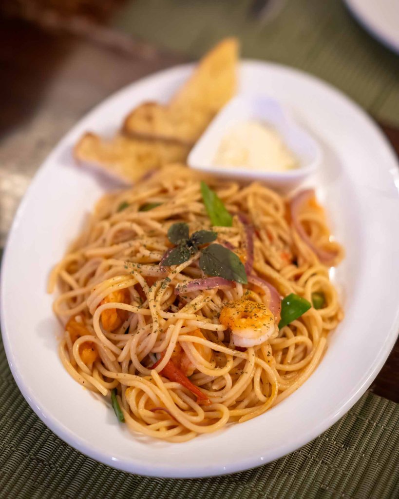 Hearty plate of Spicy Shrimp Spaghetti at TipTop Resto, showing the diverse European-inspired menu options.